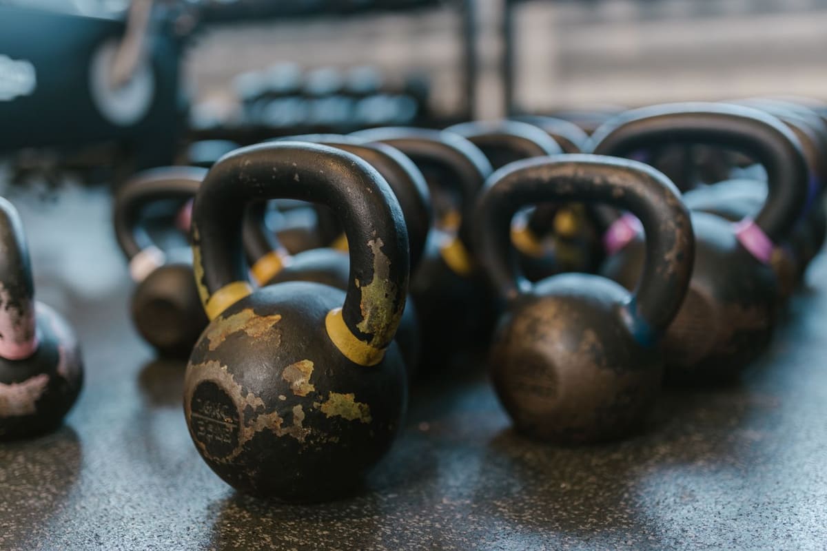 Chipped cast iron kettlebells on the rubber floor