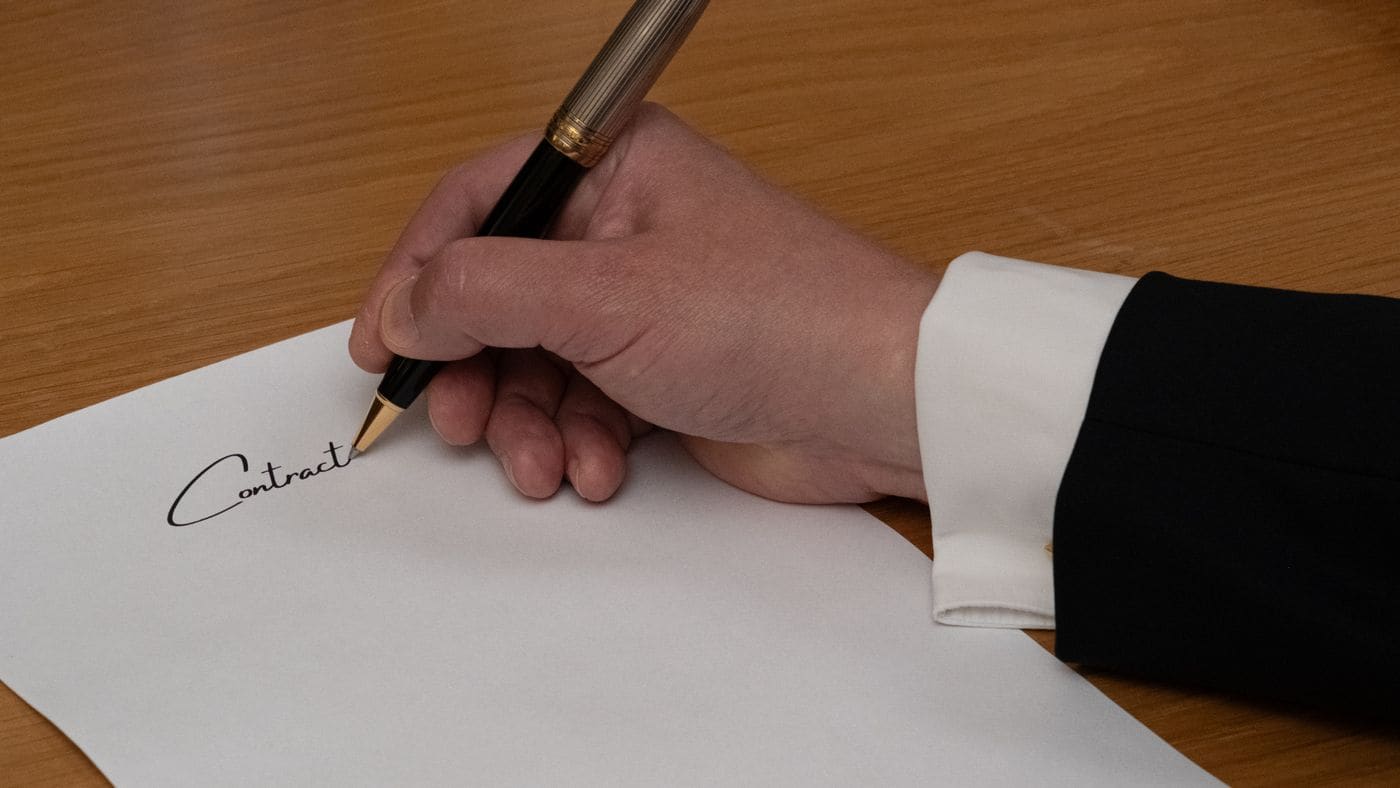 A document being signed with a fountain pen