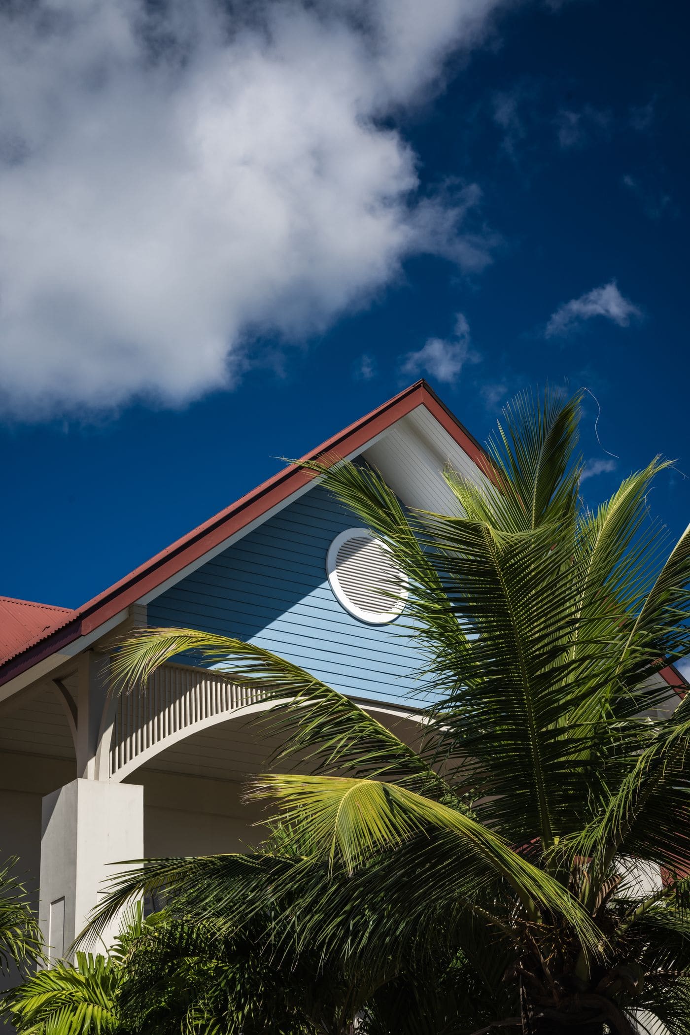 The gable of a low-rise house, out beyond the city