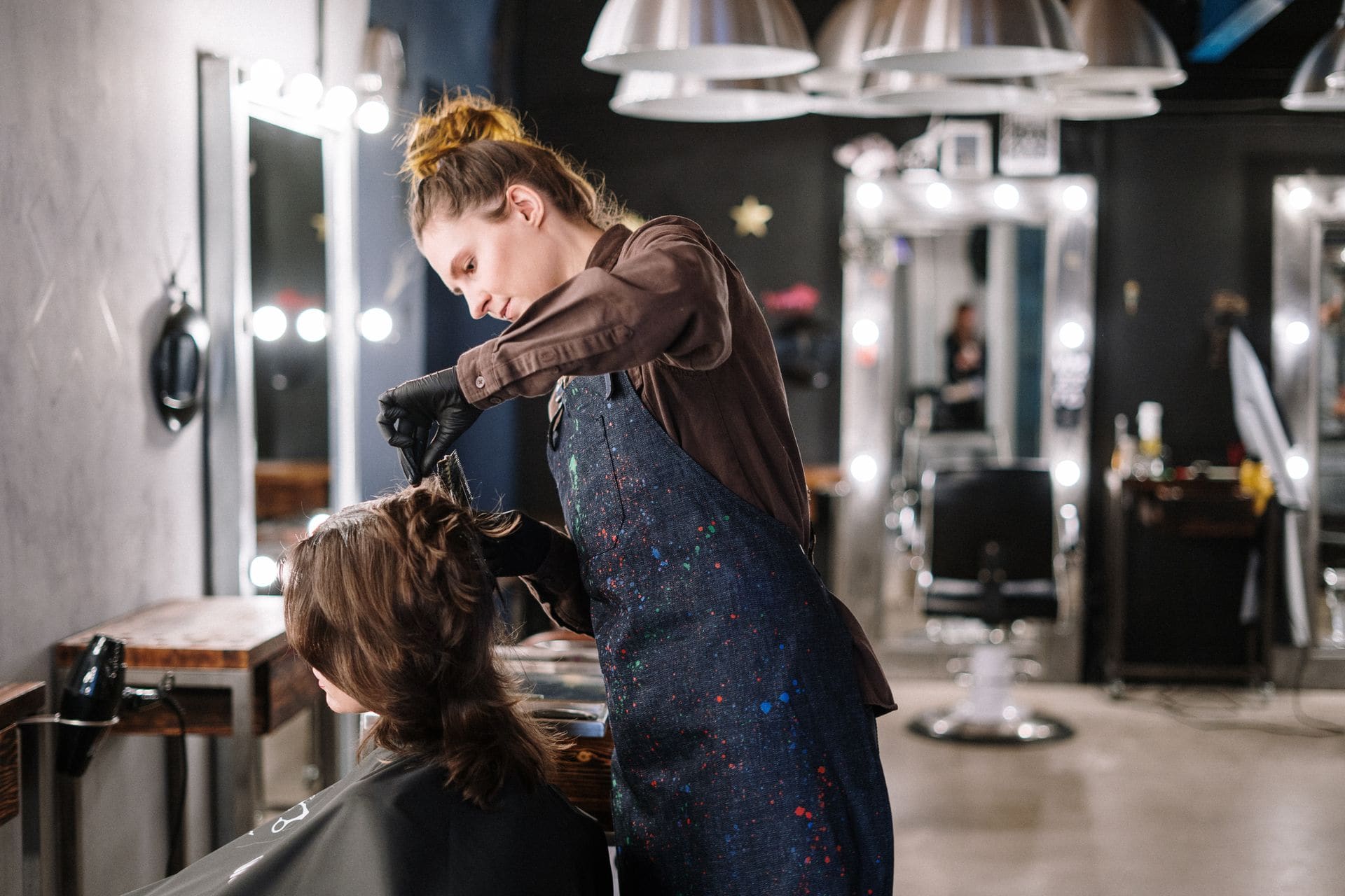 Stylist applying colour to a guest's hair at Halo